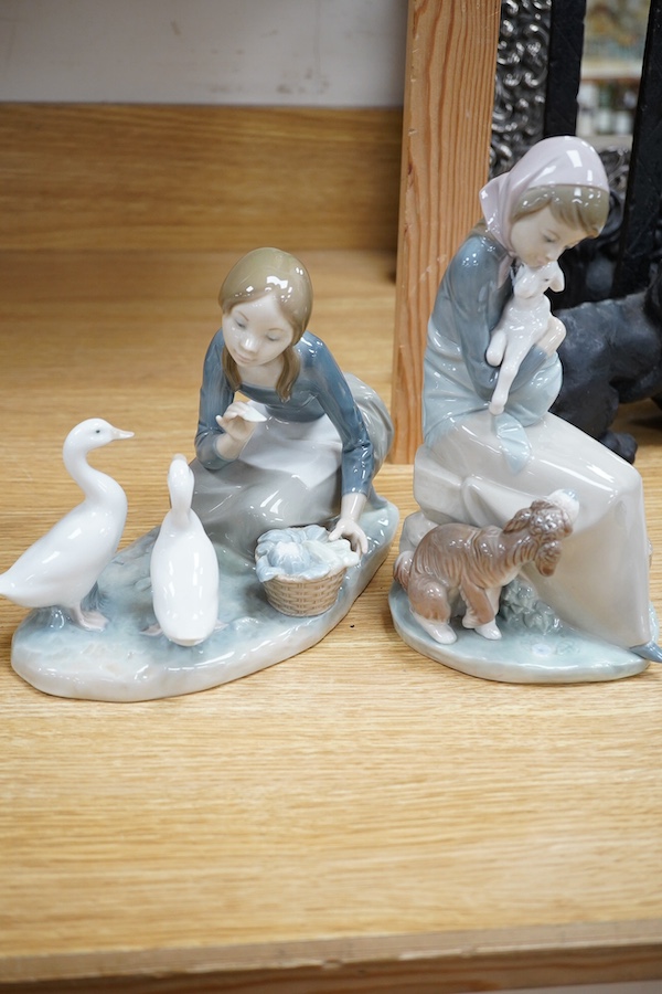 Four Lladro figures; elderly man with a dog, a girl with two ducks, a shepherdess and a boy shepherd, tallest 27cm. Condition - good